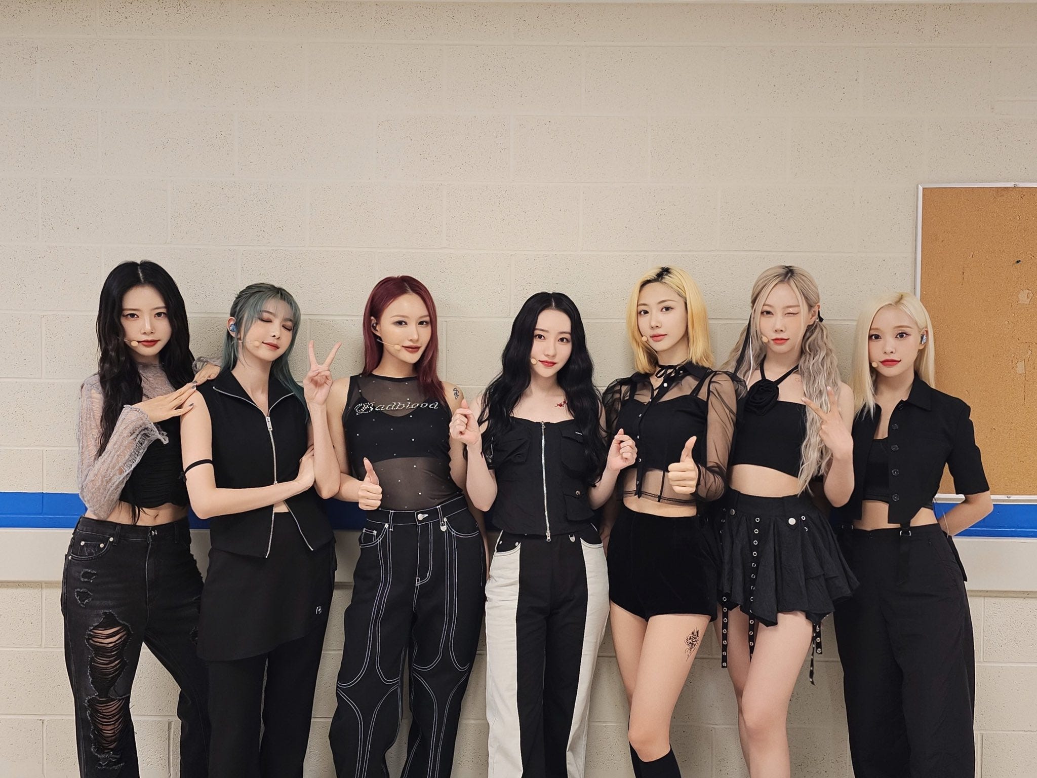 Dreamcatcher wearing black looking at the camera and posing.