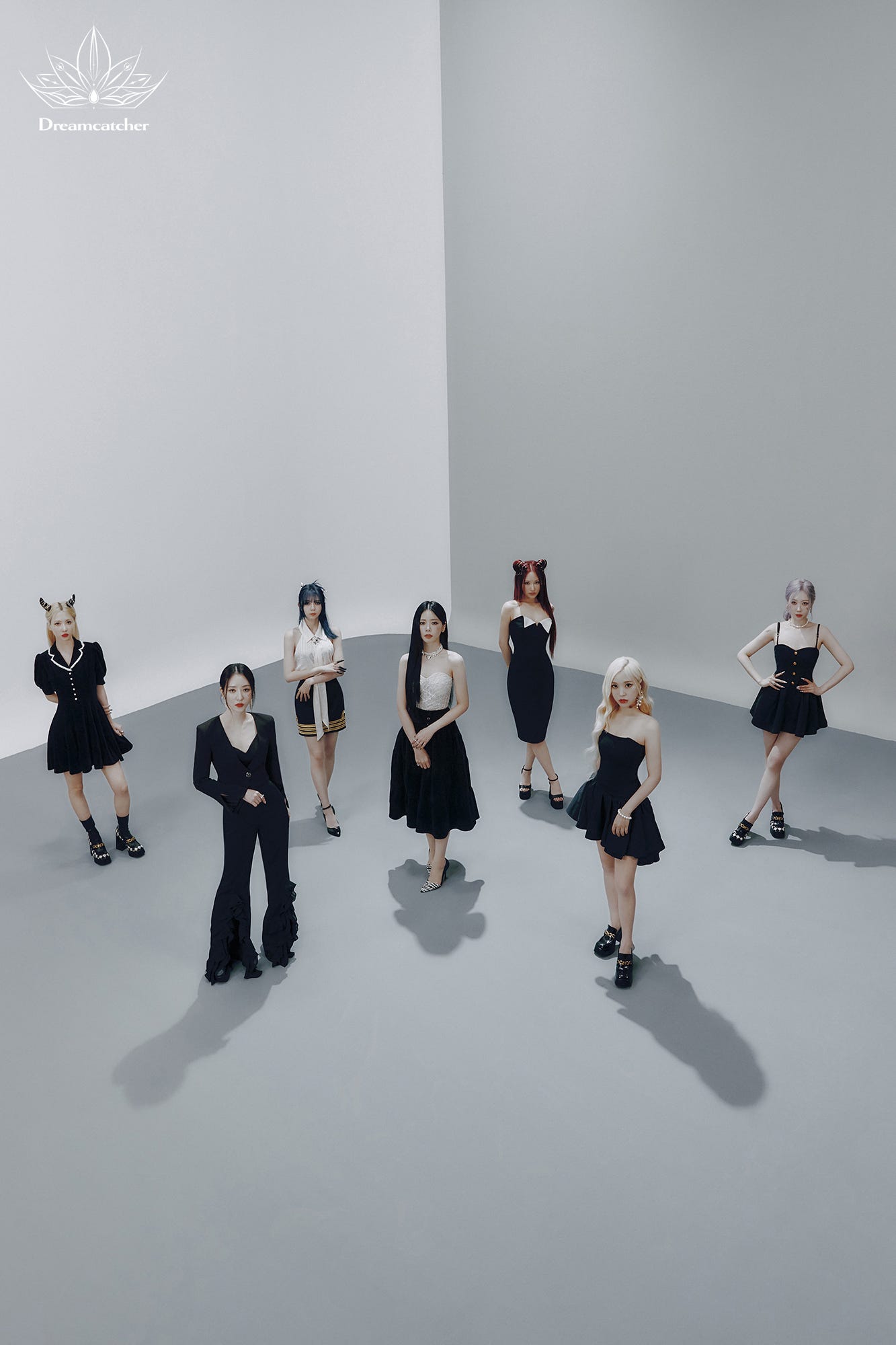 Dreamcatcher group teaser ver. 2, with a white background and farwaway shot with the group standing in front in black and white colors.