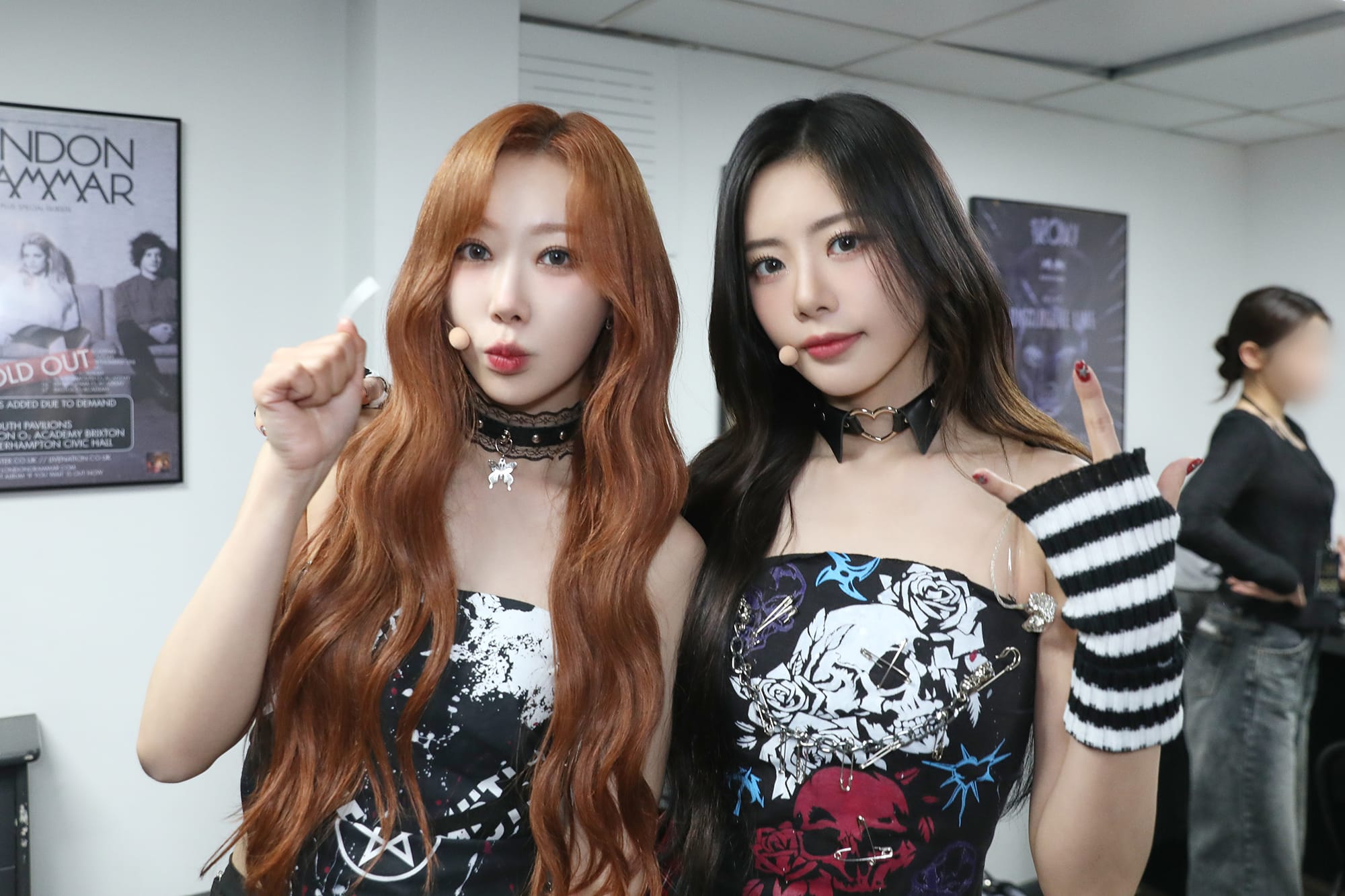 JiU and Handong, dressed in black, pose for the camera.