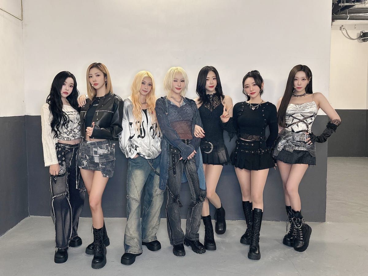 Dreamcatcher in denim, white, and black outfits smiling for the camera.