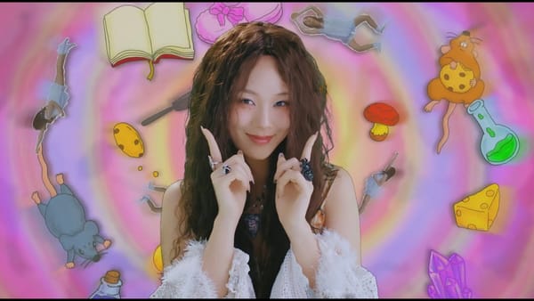 K-Pop artist BIBI smiling mischeviously while various cartoon depictions surround her.
