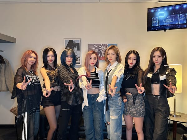 Dreamcatcher smiling for the camera forming victory signs for their concert in Seattle.