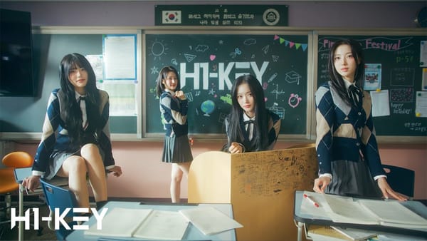 Yel, Hwiseo, Seoi, and Riina dressed as students sitting in a classroom.
